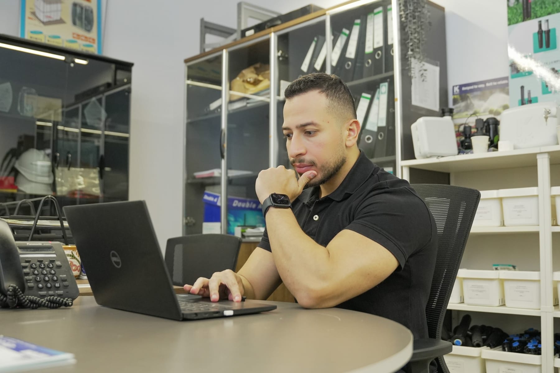 A colleague working through a problem at his laptop